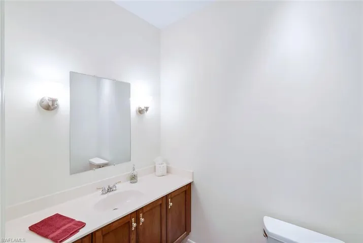 Powder room located between formal living and office.