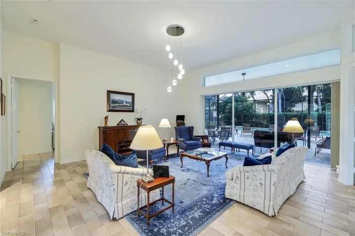 The pool area is surrounded by the formal living room, family room and the primary bedroom.