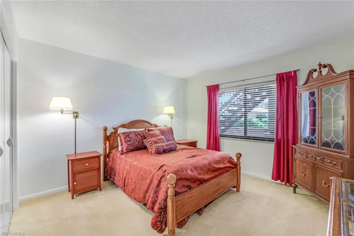 Carpeted bedroom with a textured ceiling