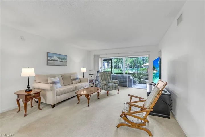 Living room featuring light colored carpet