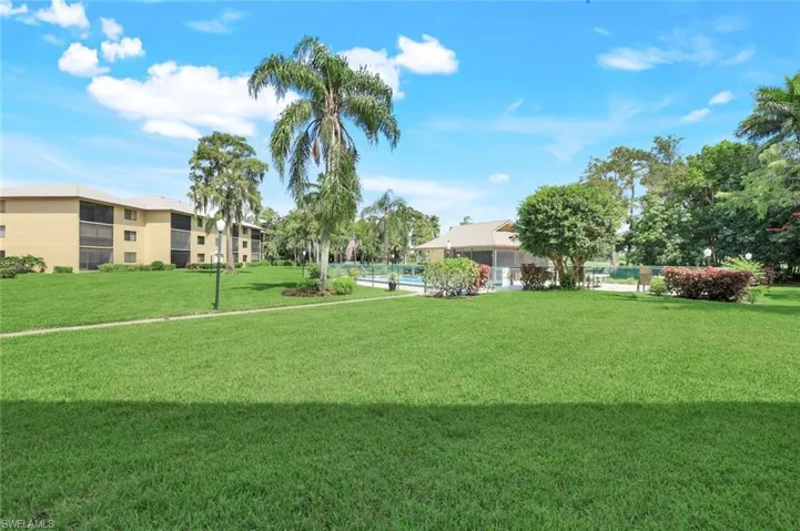 View of property's community with a lawn