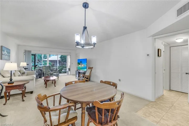 Tiled dining area with a notable chandelier