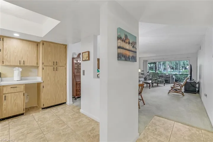 Kitchen with light brown cabinetry and light carpet