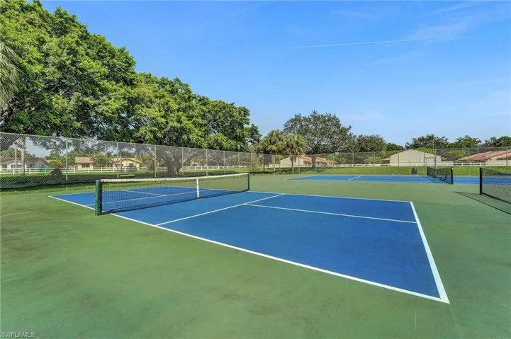 View of tennis court with community basketball court