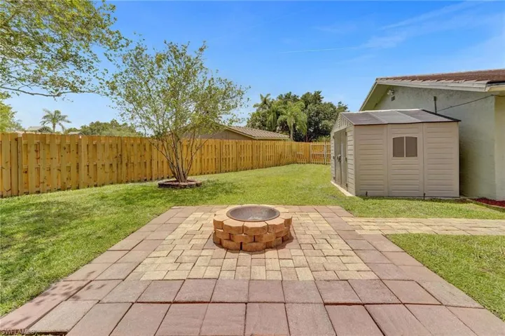 View of patio with a fire pit