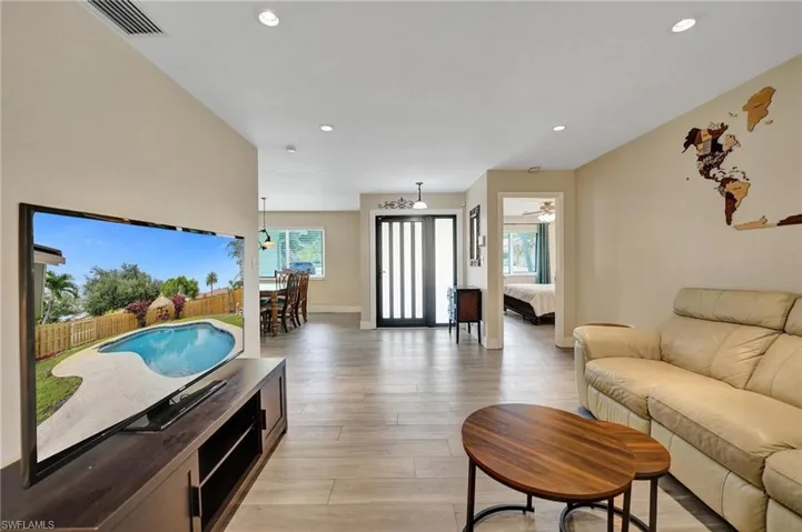 Living area with recessed lighting, light wood-style floors, baseboards, and a ceiling fan