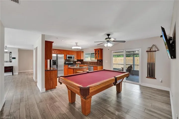 Rec room featuring baseboards, light wood-type flooring, ceiling fan, billiards table, and recessed lighting