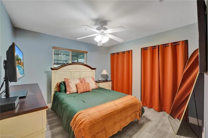Bedroom with light wood-style floors and ceiling fan