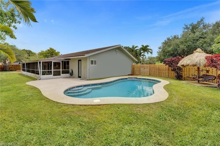 View of pool featuring a sunroom and a patio