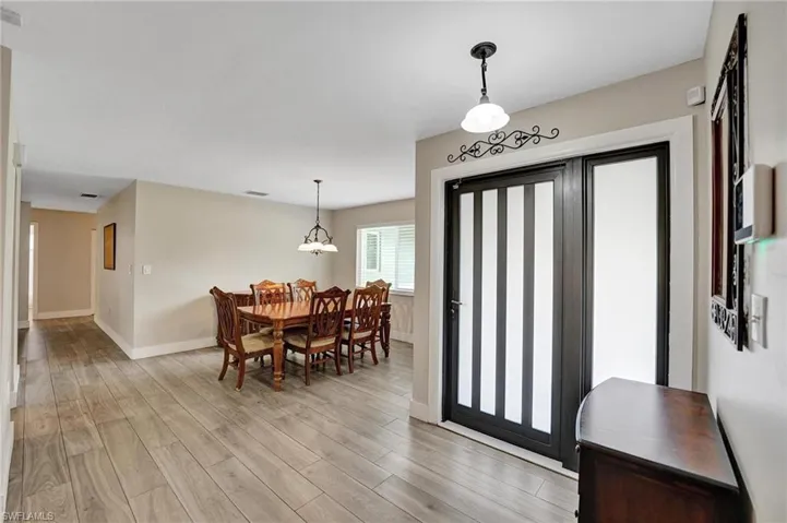 Foyer entrance featuring baseboards and light wood finished floors