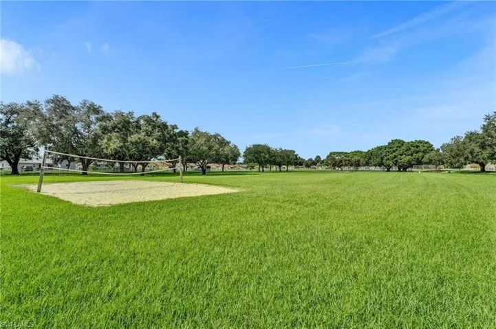 Surrounding community featuring volleyball court and a yard