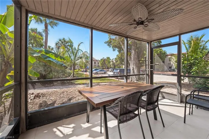Sunroom / solarium with a ceiling fan and outdoor dining area