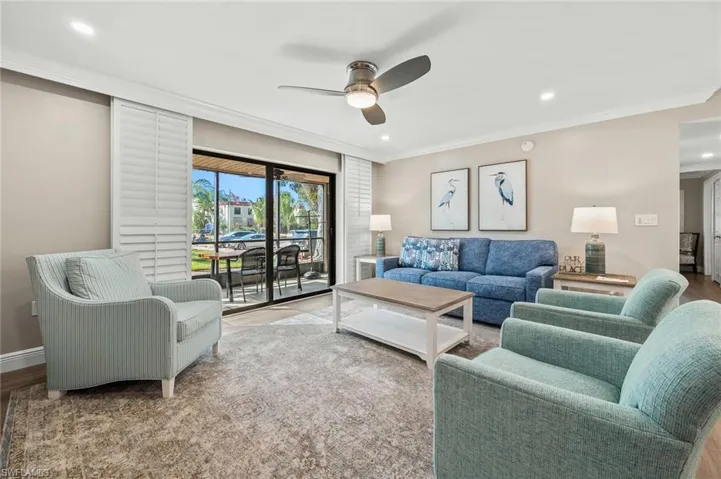 Living area featuring ceiling fan, ornamental molding, wood finished floors, and recessed lighting