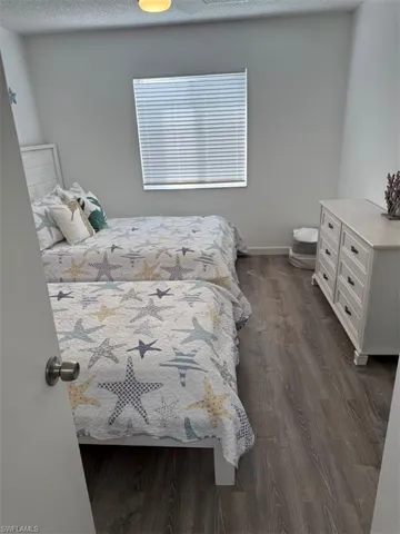 Bedroom featuring dark wood-type flooring and a textured ceiling