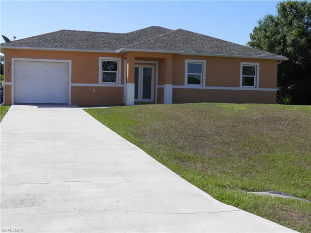 View of front of home featuring a garage and a front yard