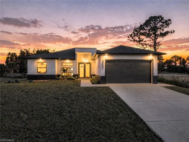 Contemporary single-story residence with a dark asphalt shingle roof, attached two-car garage, and a concrete driveway