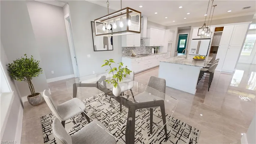 Dining room with ornamental molding, light tile flooring, and sink