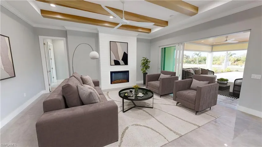 Tiled living room featuring brick wall, a fireplace, ceiling fan, crown molding, and beam ceiling
