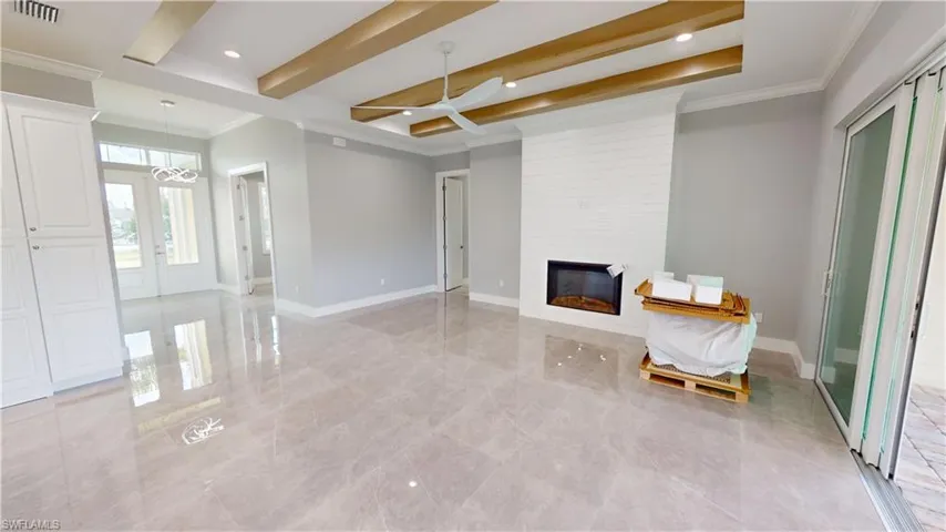 Great room with fireplace and beamed ceiling