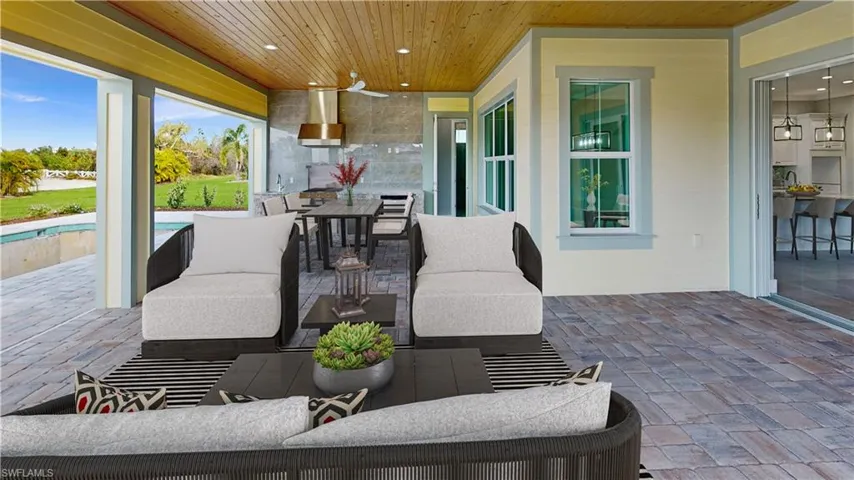 View of patio with an outdoor hangout area and ceiling fan