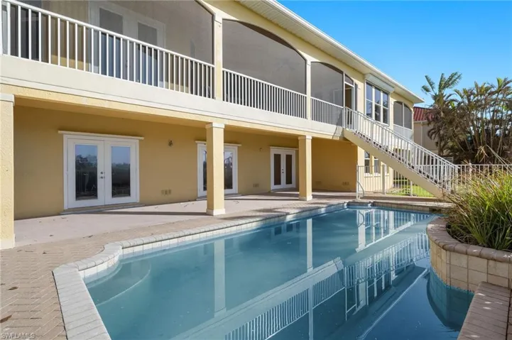 View of pool with a patio and french doors
