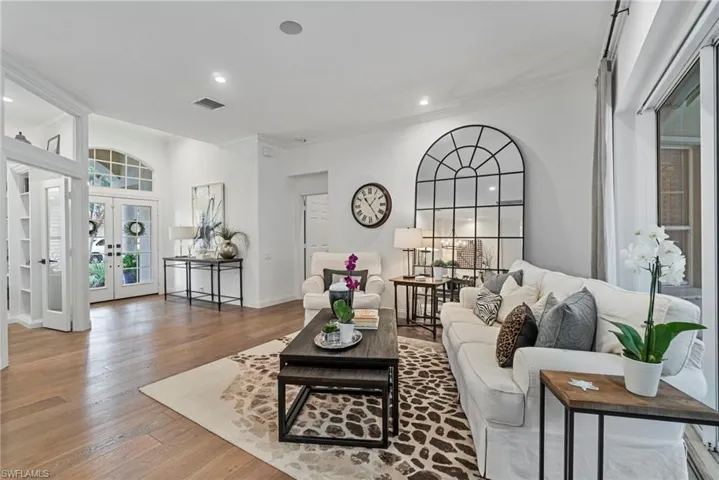 Bright Living Room with walls of sliders and hardwood floors