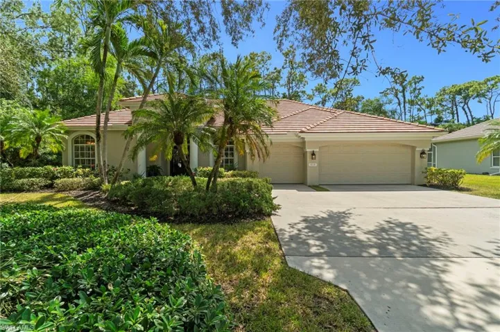 Front yard shaded by majestic oaks