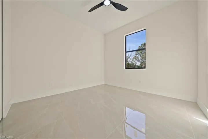 Spare room with vaulted ceiling and ceiling fan