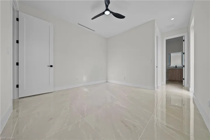 Empty room with a ceiling fan and recessed lighting