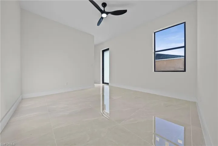 Unfurnished room featuring baseboards and ceiling fan