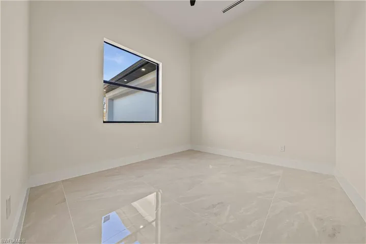 Empty room featuring baseboards