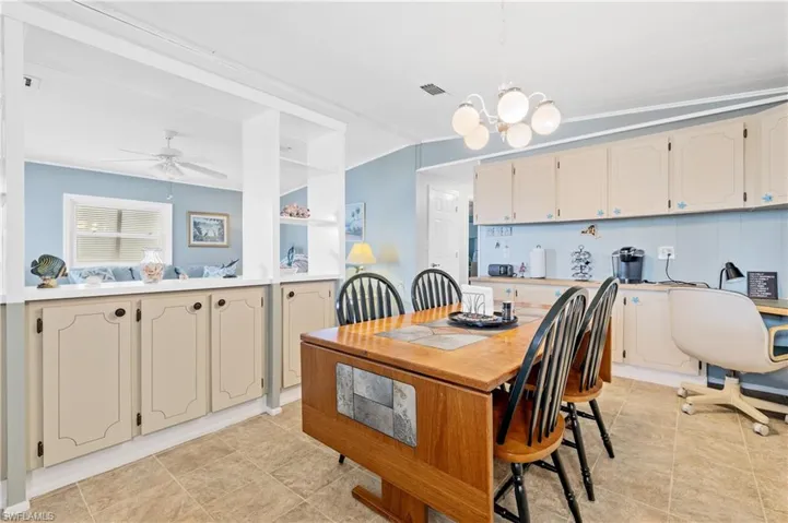 Dining area with a ceiling fan and a chandelier