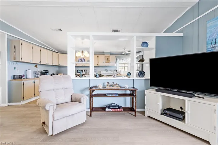 Living room with light wood-style floors and crown molding