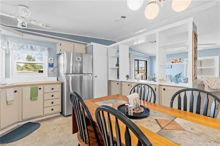 Dining space featuring plenty of natural light, crown molding, light tile patterned floors, and hanging lights