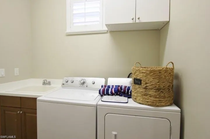 Washroom with cabinet space and independent washer and dryer