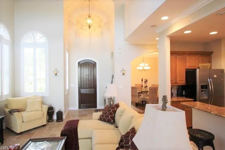Living room featuring a chandelier, arched walkways, and recessed lighting