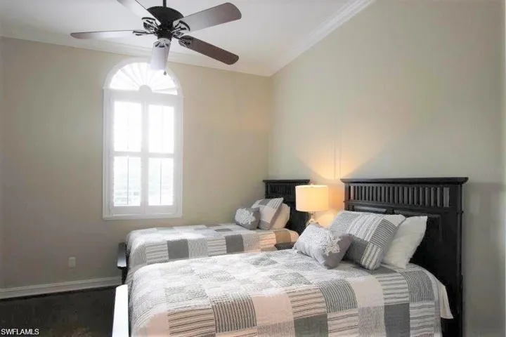 Bedroom featuring crown molding and a ceiling fan
