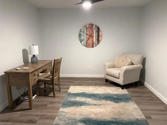 Office area featuring baseboards and wood finished floors