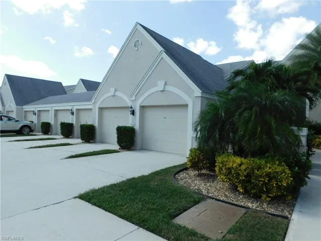 View of front of house featuring driveway and stucco siding
