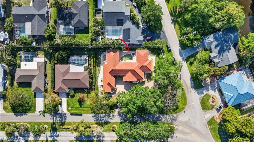 Aerial view of the property, featuring a red tile roof and a central courtyard