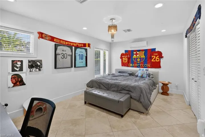 This room features light-colored tile flooring, white walls, and recessed lighting