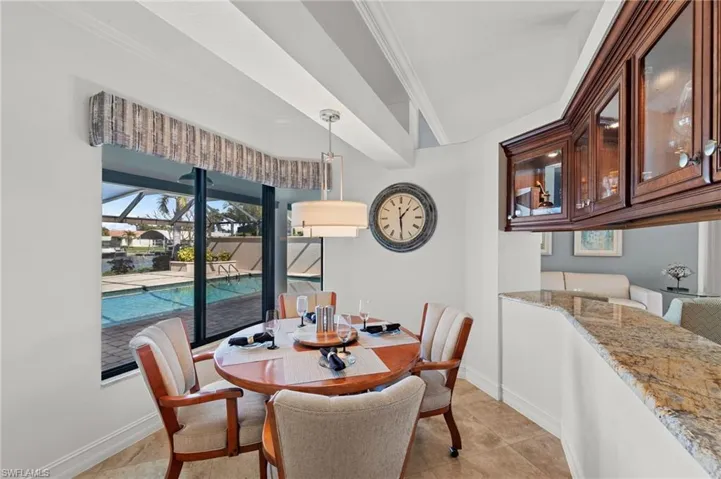 Dining space featuring crown molding, light tile patterned flooring, and a sunroom