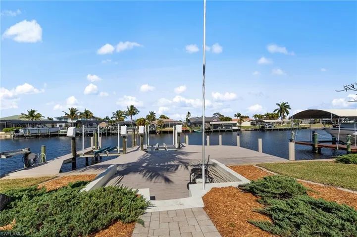 Dock area featuring boat lift and a water view