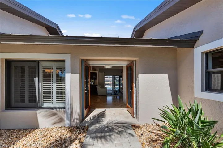 Doorway to property with stucco siding
