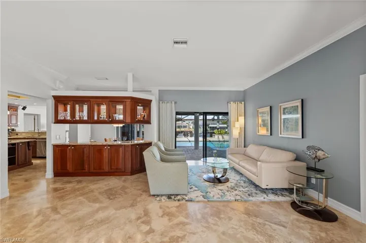 Living area featuring crown molding