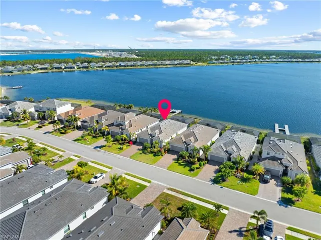 Birds eye view of property with a water view