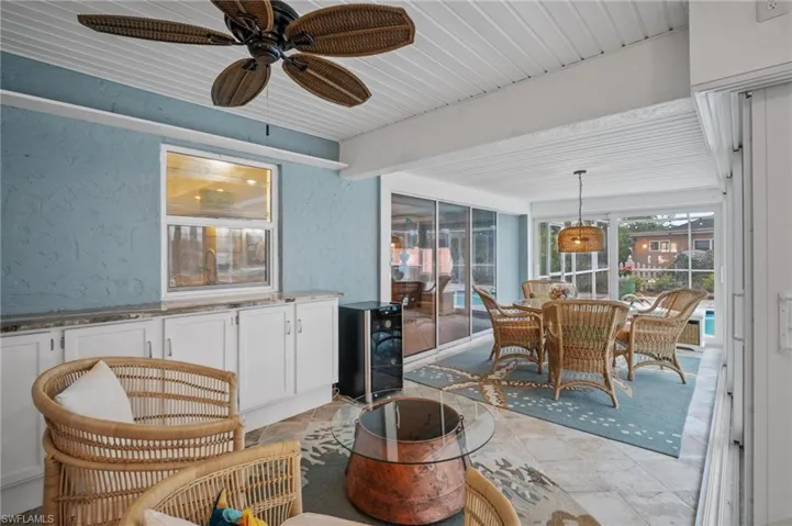 Sunroom featuring wine cooler and ceiling fan