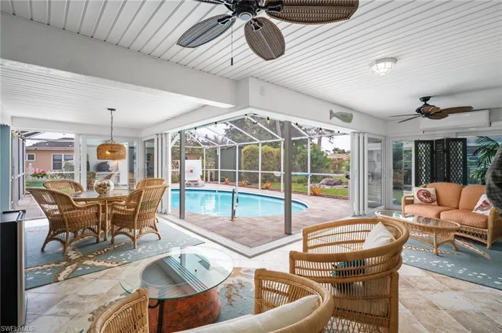 View of pool with ceiling fan