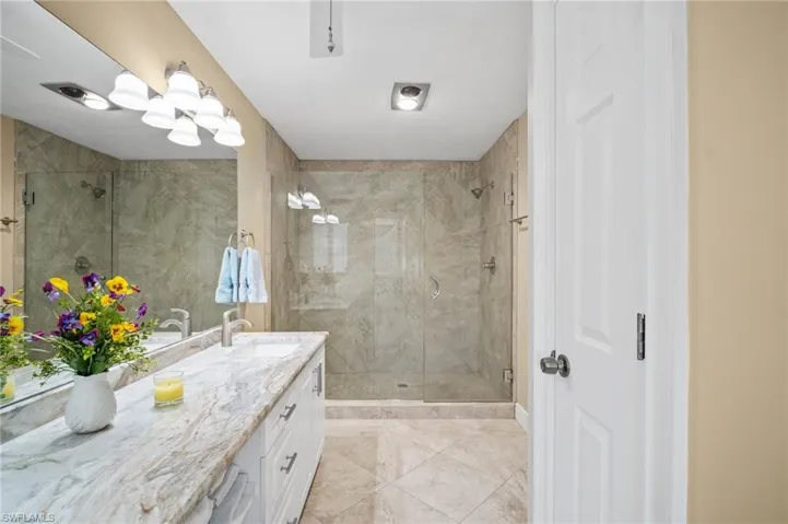 Full bathroom with vanity and a stall shower