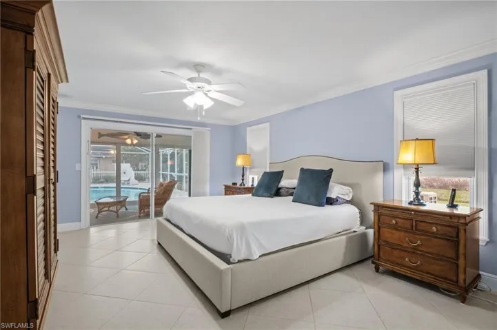 Bedroom featuring access to exterior, light tile patterned floors, crown molding, and ceiling fan